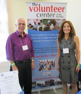 2 volunteers with banner